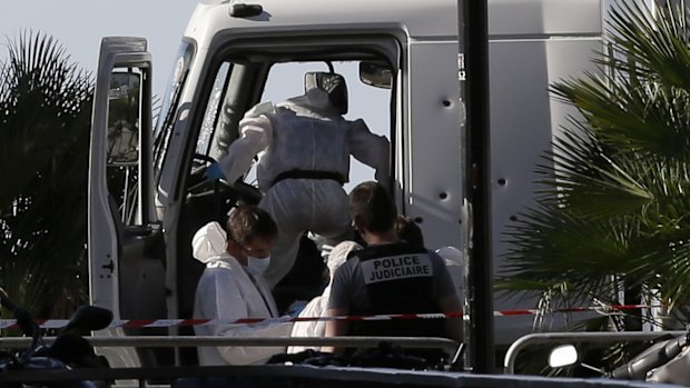 Forensic police officers examine the truck after the deadly attack.