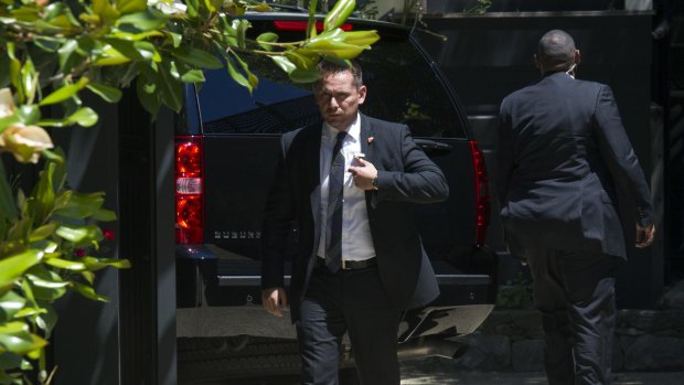 Secret Service stand guard around a Secret Service vehicle outside Hillary Clinton's home in Washington on Saturday.