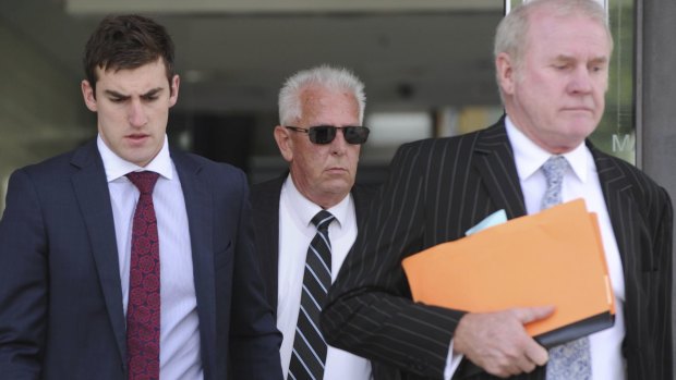 Peter Cuzner (middle) leaves the ACT Magistrates Court in February. 