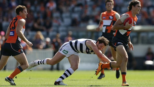 Phil Davis of the Giants gets away from Patrick Dangerfield.