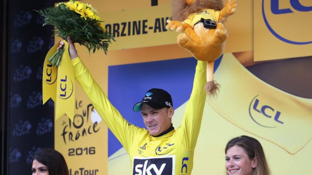 Chris Froome of Team Sky celebrates as he retains the Yellow Jersey following stage 20 of the Tour de France.
