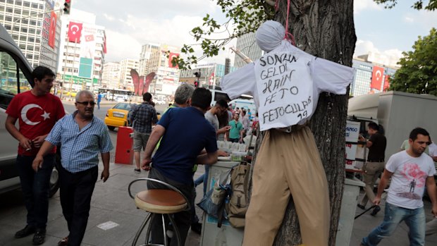 People pass by an effigy of Fethullah Gulen in Ankara, Turkey.