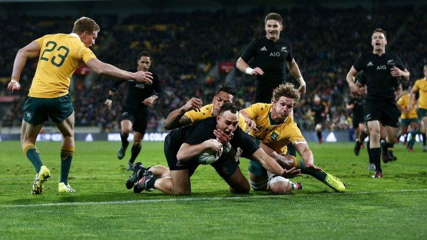 One-way traffic: Israel Dagg scores a try as Israel Folau and Michael Hooper try to defend during the Bledisloe Cup match between the All Blacks and Australia Wallabies at Westpac Stadium.