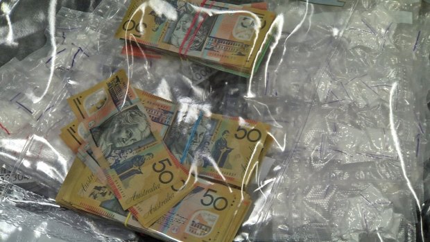 Cash and drugs seized during raids in 2015. 