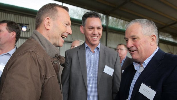 Nationals candidate Michael Neoh (centre) and Moyne Shire mayor Colin Ryan meet Prime Minister Tony Abbott at a farm in Woolsthorpe. 