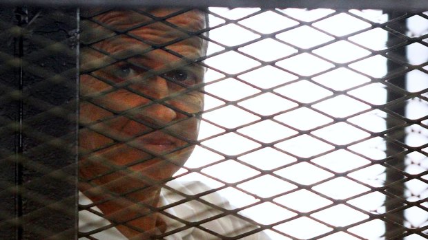 Jailed journalist Peter Greste in the defendant's cage in court earlier this year.