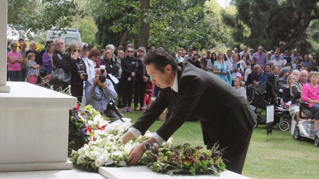 Japanese Parliamentary Vice-Minister for Foreign Affairs Hitoshi Kikawada offers flowers during a memorial ceremony in Christchurch on Monday.