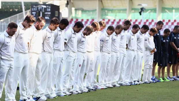 New Zealand cricket players wear black armbands and observe a minute's silence during day two of the third Test between Pakistan and New Zealand in Sharjah.