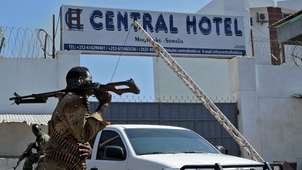 Somali security forces guard the entrance to the Central Hotel, close to the presidential palace, in Mogadishu after Somalia's Al-Qaeda-linked Shebab insurgents killed at least 25 people at the popular hotel.