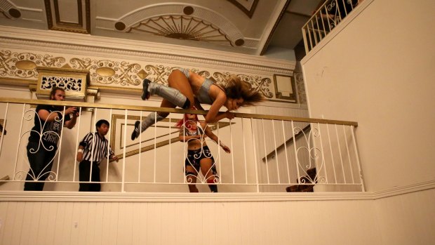 Kellyanne throws Evie over a railing during their Melbourne City Wrestling match.