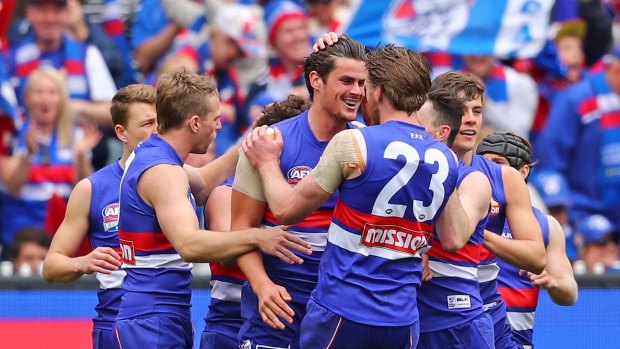 Roughead (#23) and teammates congratulate Tom Boyd after he kicked a goal during the 2016 Grand Final. 