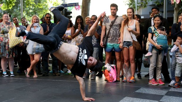 Going all-out: A member of the Young Masters break-dancing crew performing in Swanston Street. 
