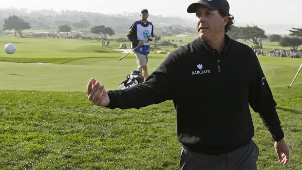 Feeling good: Phil Mickelson tosses his ball to the gallery.