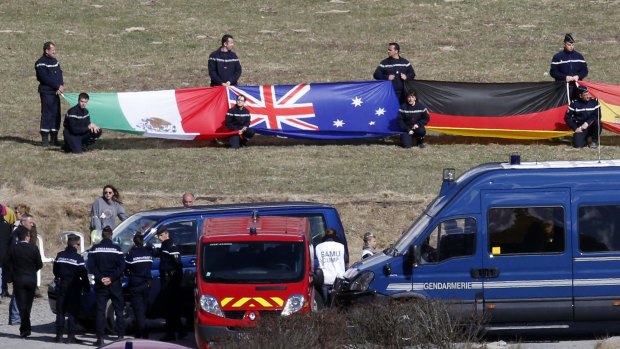 The Australian flag is displayed at a ceremony to pay tribute March 30, 2015 to the two Australians among 150 victims of the Germanwings Airbus A320.