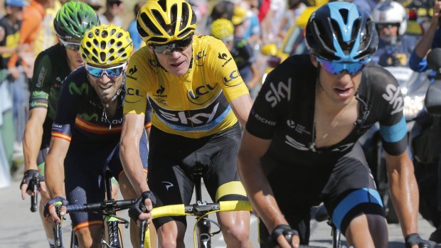 Britain's Chris Froome, wearing the overall leader's yellow jersey, defended by Australia's Richie Porte (right).