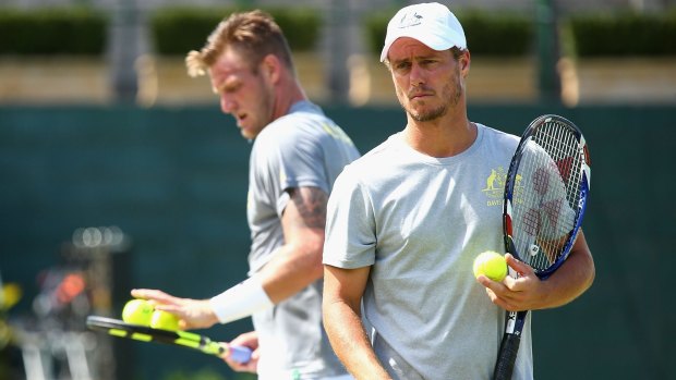 Lleyton Hewitt and Sam Groth limber up for the Davis Cup tie against the US.