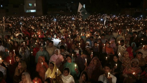 Pakistani Christians hold candles during a vigil for victims of a suicide bombing in Lahore in March.