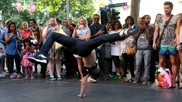 A member of the Young Masters break-dancing crew from the western suburbs performs outside Cafe L'Incontro in Swanston Street on Tuesday.