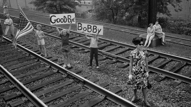Kids bearing signs greet Robert F. Kennedy's funeral train as it passed near Elizabeth, New Jersey. 