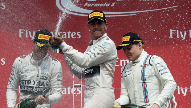 Lewis Hamilton (centre), Nico Rosberg (left) and Valtteri Bottas celebrate on the podium.