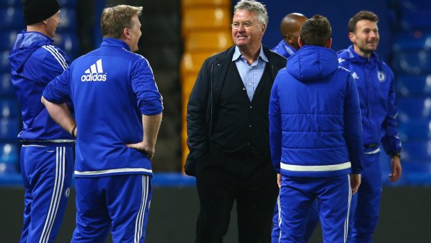 Chelsea interim manager Guus Hiddink talks with staff after their 3-1 win.