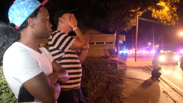 Jermaine Towns, left, and Brandon Shuford wait down the street from the multiple shooting at Pulse nightclub in Orlando.