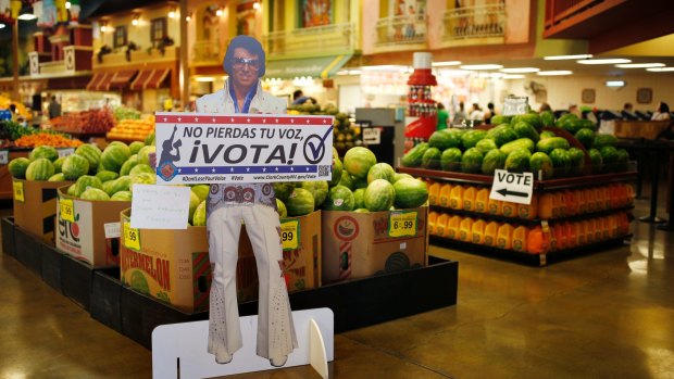 A sign in Spanish which translates, "Don't Lose Your Voice, Vote!" is displayed near a polling place in a Cardenas supermarket in Las Vegas.