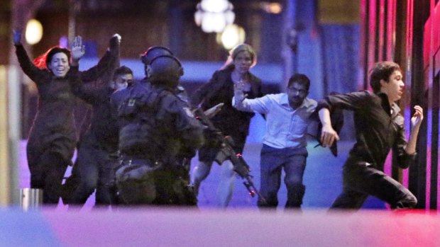 Hostages flee from the Lindt Cafe during the siege.