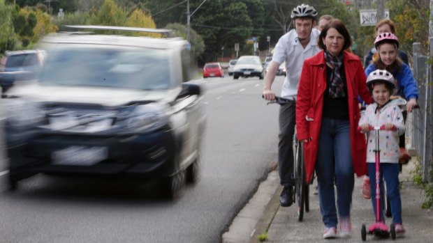 People crossing the Heidelberg Road bridge.