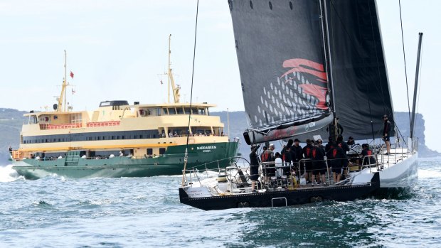 Iconic Sydney: LDV Comanche passes a ferry during a practice sail ahead of the Sydney to Hobart.