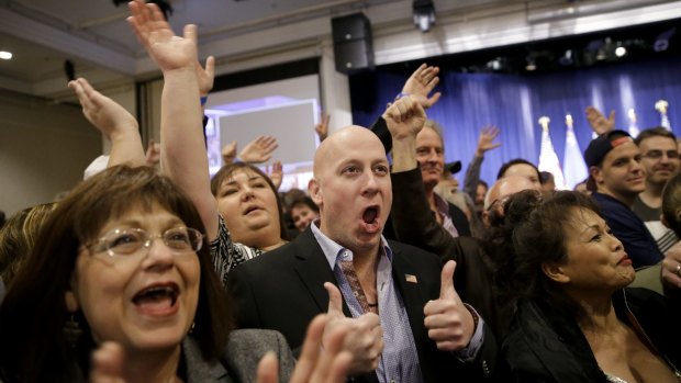 Angry voters align with Trump camp: Supporters cheer during a caucus night rally for Donald Trump.