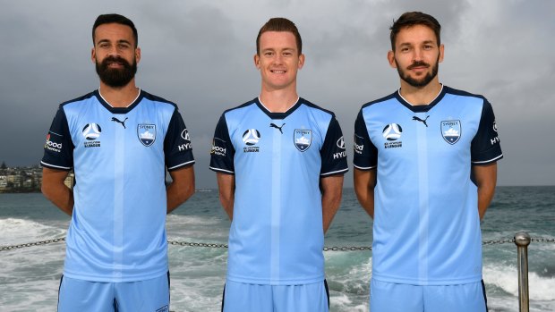 Title defence: Milos Ninkovic, right, with Alex Brosque, left, and Brandon O'Neill.