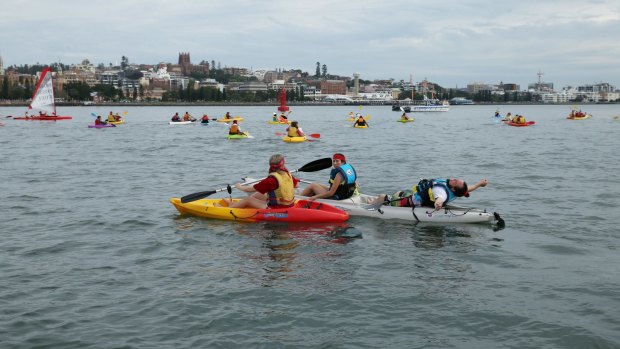 Protesters in kayaks in Newcastle harbour. 