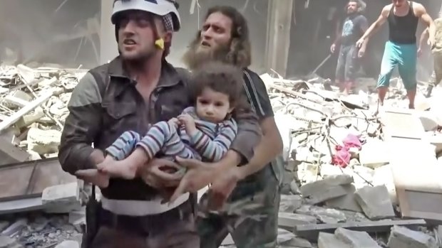 A Civil Defence worker carries a child after airstrikes hit Aleppo, Syria - another complex part of the world.