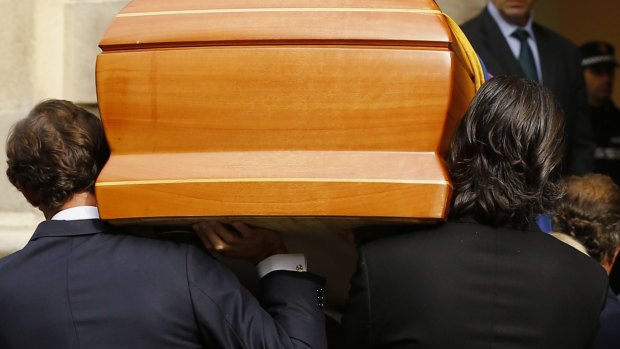 Family members carry in her coffin.