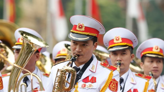 Military music band play before a welcoming ceremony for Japan's Prime Minister Shinzo Abe at the Presidential Palace in Hanoi.