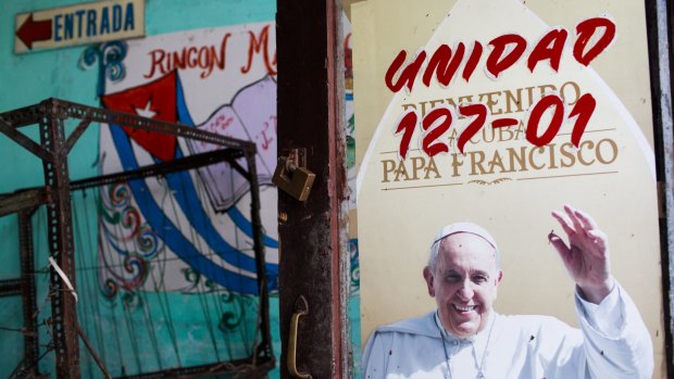 A sign welcoming Pope Francis is displayed at a bodega in Havana, Cuba.