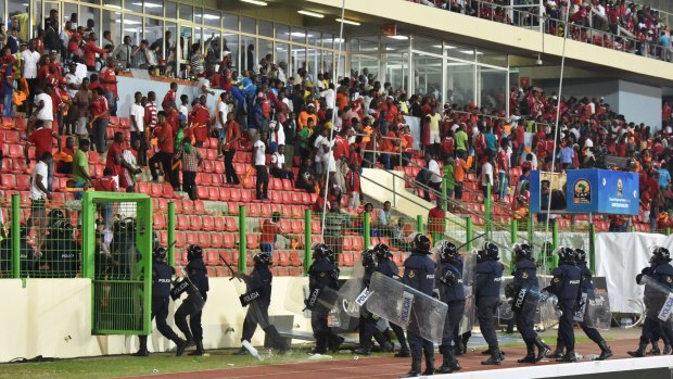 Policemen evacuate a tribune during the 2015 African Cup of Nations semi-final