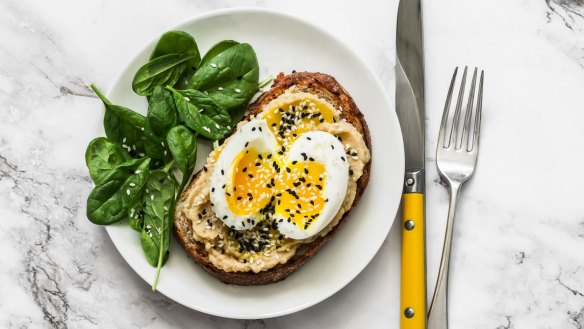 Hummus and boiled egg on toast is a healthy breakfast.