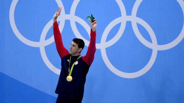 Gold No. 20: Michael Phelps of the US on the podium during the medal ceremony for the men's 200m butterfly final.