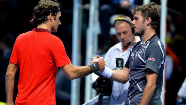 Tense match: Rodger Federer shakes hands with  Stanislas Wawrinka.