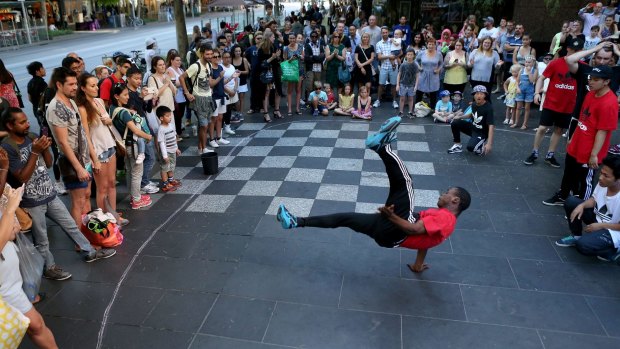 Busting a move: Lonowon Kokeh from the Young Masters break-dancing crew performs in Swanston Street on Tuesday.