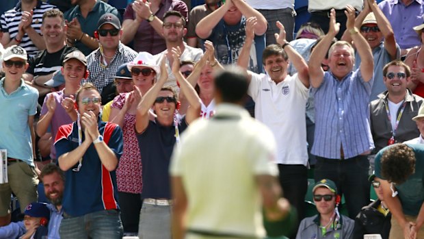 The crowd applaud Mitchell Johnson as he concedes his 100th run.