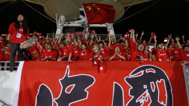 China soccer fans wave the national flag before the 2018 World Cup Asian qualifying match against Hong Kong.