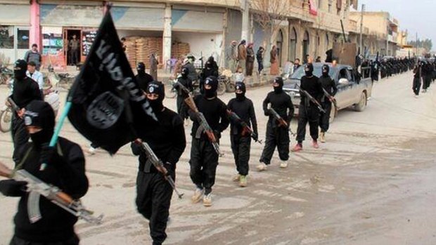 Fighters from Islamic State march through Raqqa, Syria in January 2014. 