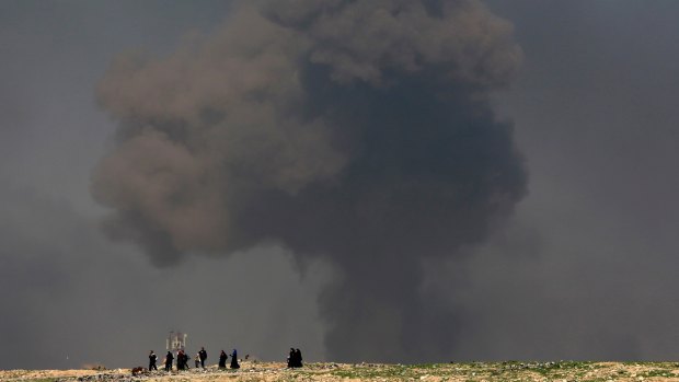 A large cloud of smoke rises during fighting between Iraqi security forces and Islamic State militants in early March.