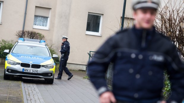 Police officers in front of a house in Duesseldorf, where a German magazine says two people with possible links to the Brussels attacks were arrested on Friday.