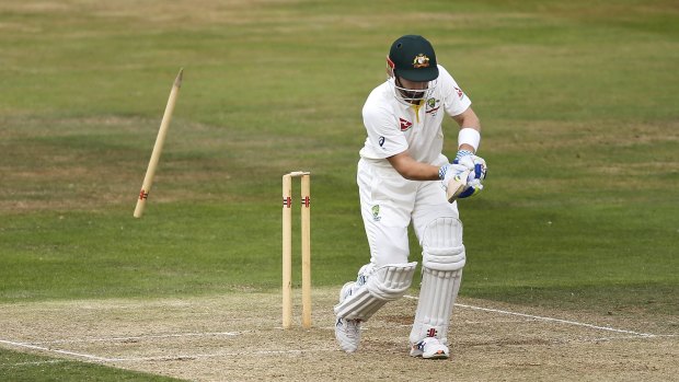 Australia's Peter Nevill is bowled by Northamptonshire's Steven Crook.