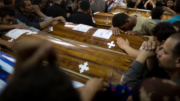 Relatives mourn the deaths of the Christians .