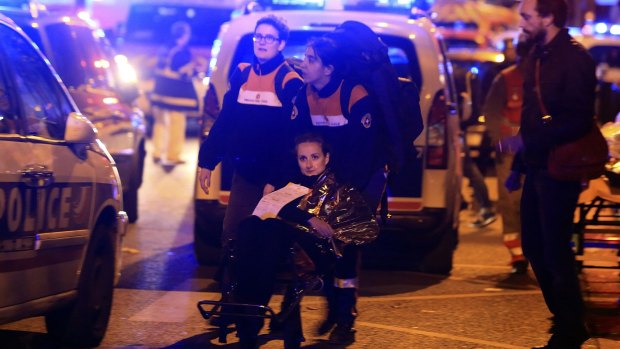 A woman is evacuated from the Bataclan theatre after the attack.